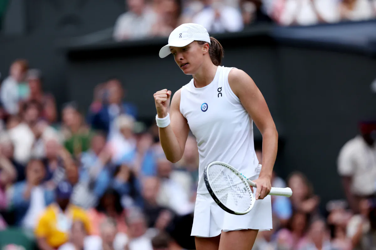 Iga Swiatek of Poland celebrates winning match point against Belinda Bencic of Switzerland in the women's singles fourth round match during day seven of The Championships Wimbledon 2023 at All England Lawn Tennis and Croquet Club in London, England, on July 9, 2023. (Clive Brunskill/Getty Images)