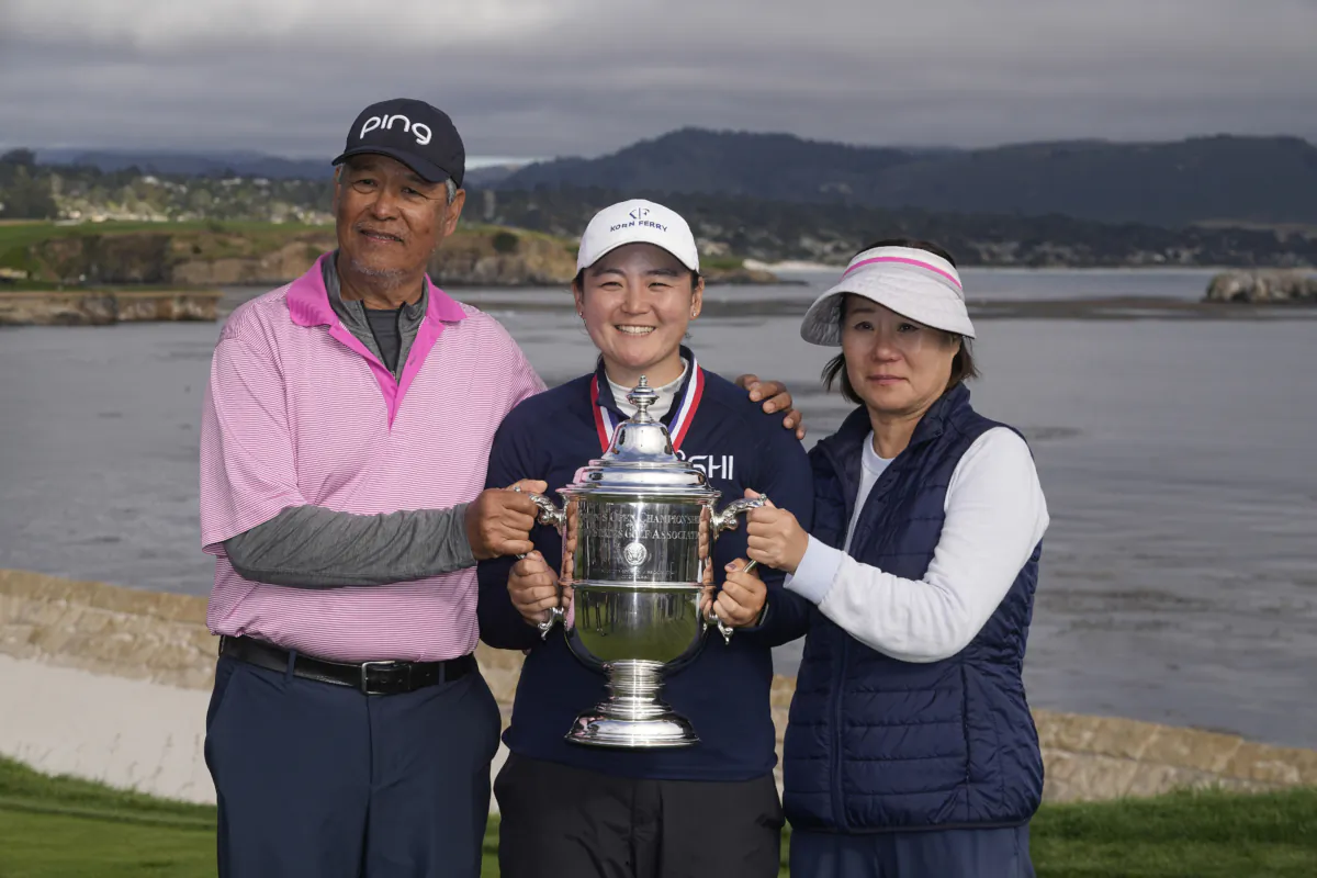 Allisen Corpuz poses with her parents after winning the U.S. Women's Open golf tournament at the Pebble Beach Golf Links, in Pebble Beach, Calif., July 9, 2023. (Darron Cummings/AP Photo)