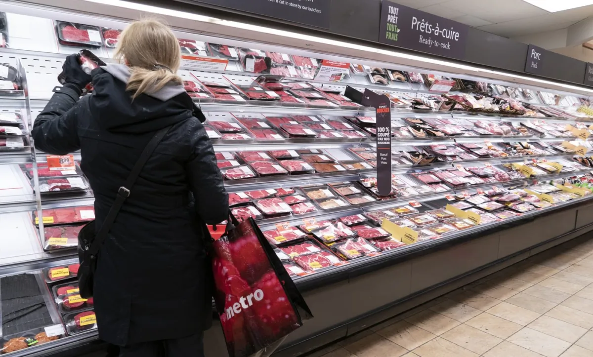 A woman shops at the meat counter of a grocery store in Montreal on April 30, 2020. (The Canadian Press/Paul Chiasson)