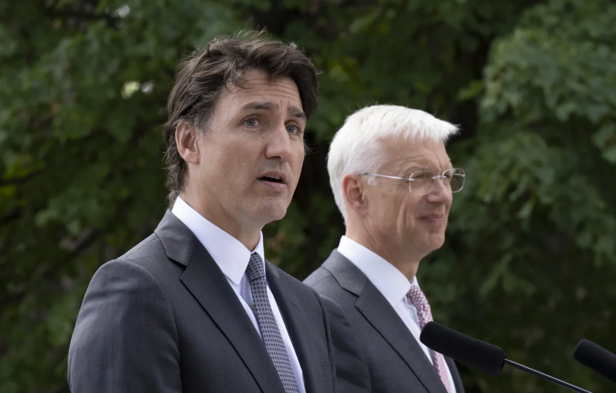 Latvian Prime Minister Krisjanis Karins (right) looks on as 
Prime Minister Justin Trudeau speaks during a joint media availability at the Adazi Military base, July 10, 2023 in Adazi, Latvia. (The Canadian Press/Adrian Wyld)
