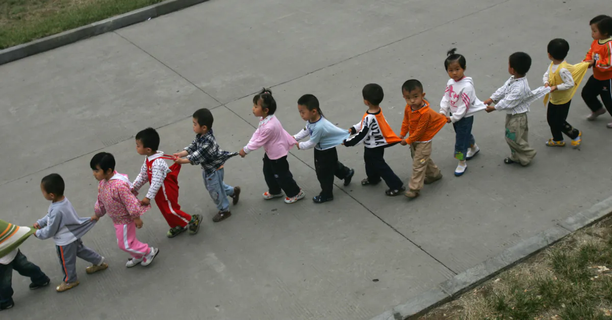 Kindergartners walk in Shandong Province, China, on May 21, 2007. (China Photos/Getty Images)
