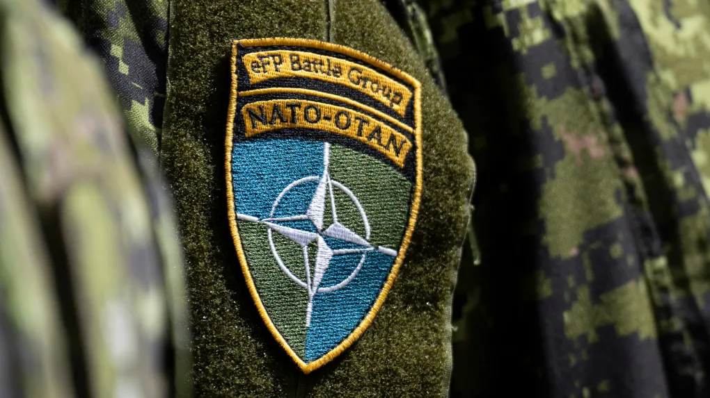 A Canadian soldier wears the NATO Battle Group patch as he listens to Prime Minister Justin Trudeau speak at the Adazi Military base, in Adazi, Latvia, on July 10, 2023. (/
The Canadian Press/Adrian Wyld)
