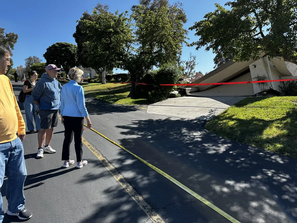 LA County Supervisor Janice Hahn stands with homeowners watching their houses sink from a landslide in Rolling Hills Estates in Los Angeles, Calif., on July 9, 2023. (Courtesy of Los Angeles County Supervisor Janice Hahn)