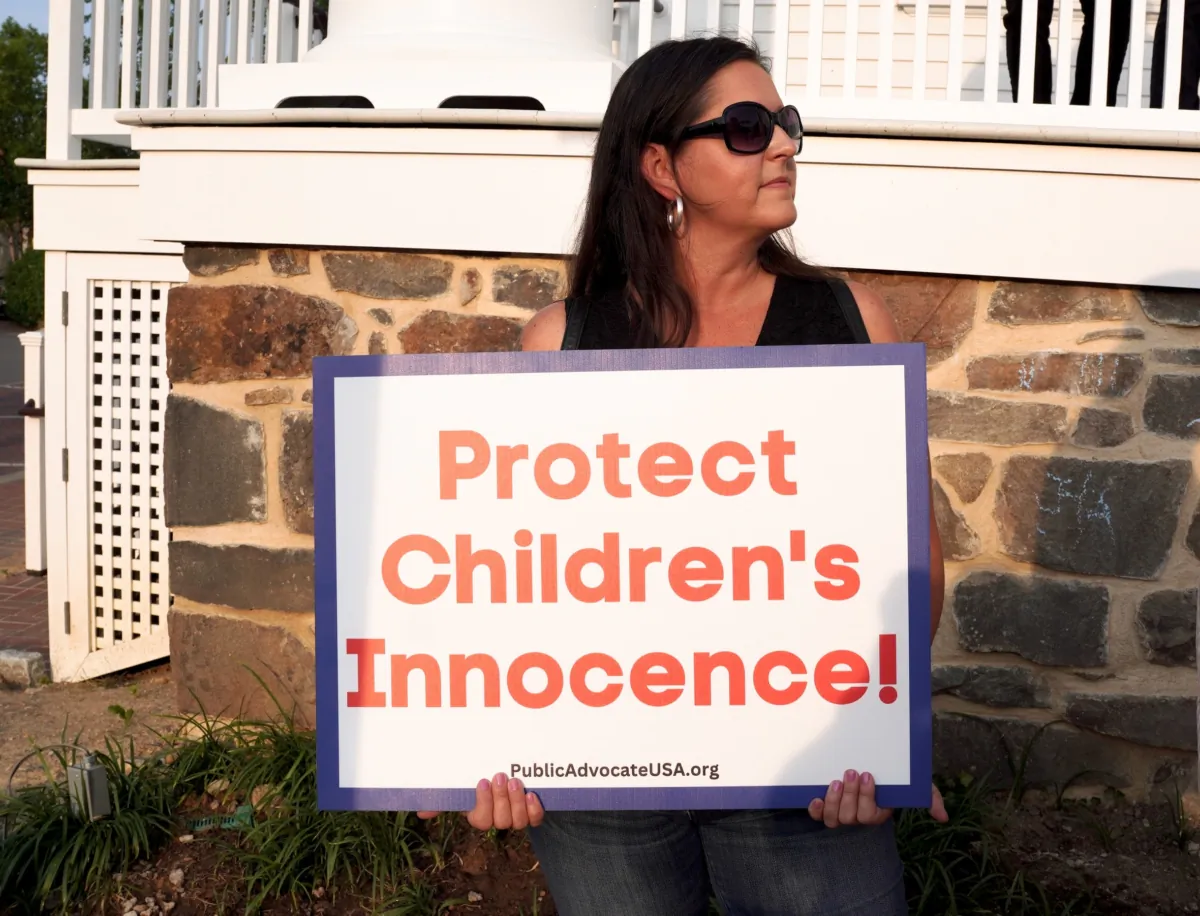 A woman protests a pride month event featuring drag queen performances outside the old town hall in Fairfax, Va., on Jun. 3, 2023. (Terri Wu/The Epoch Times)