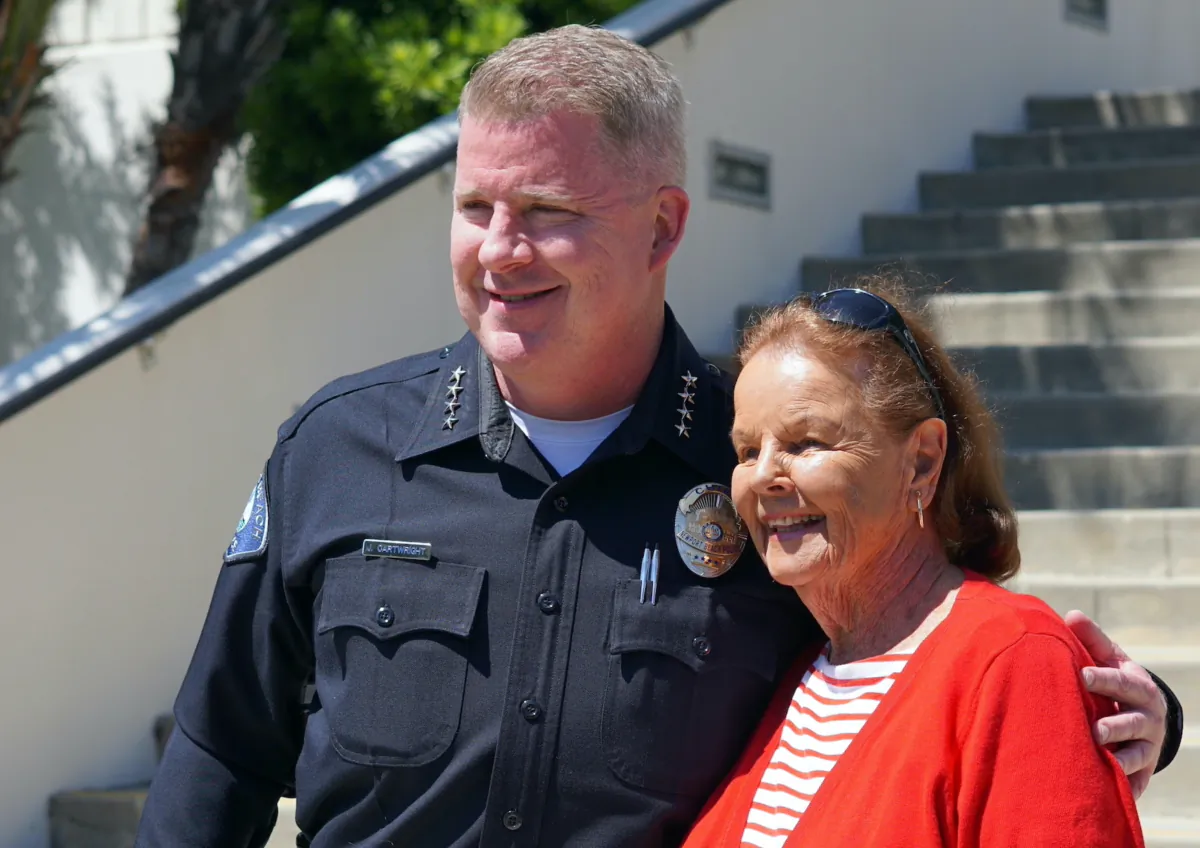 Dotty McDonald (R), a 94-year-old local resident, stands next to Newport Beach Police Chief Joe Cartwright in Newport Beach, Calif., on July 5, 2023. (Courtesy of Logan Edwards)