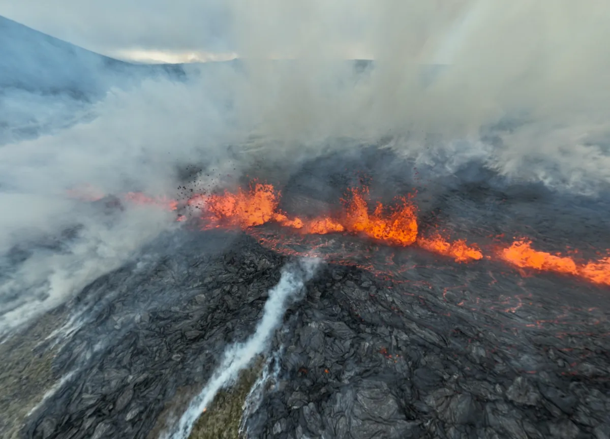 Smoke billows and lava spurts after the eruption of a volcano, on the Reykjanes peninsula, near the capital Reykjavik, in southwest Iceland, on July 10, 2023. (Juergen Merz/Glacier Photo Artist via Reuters)