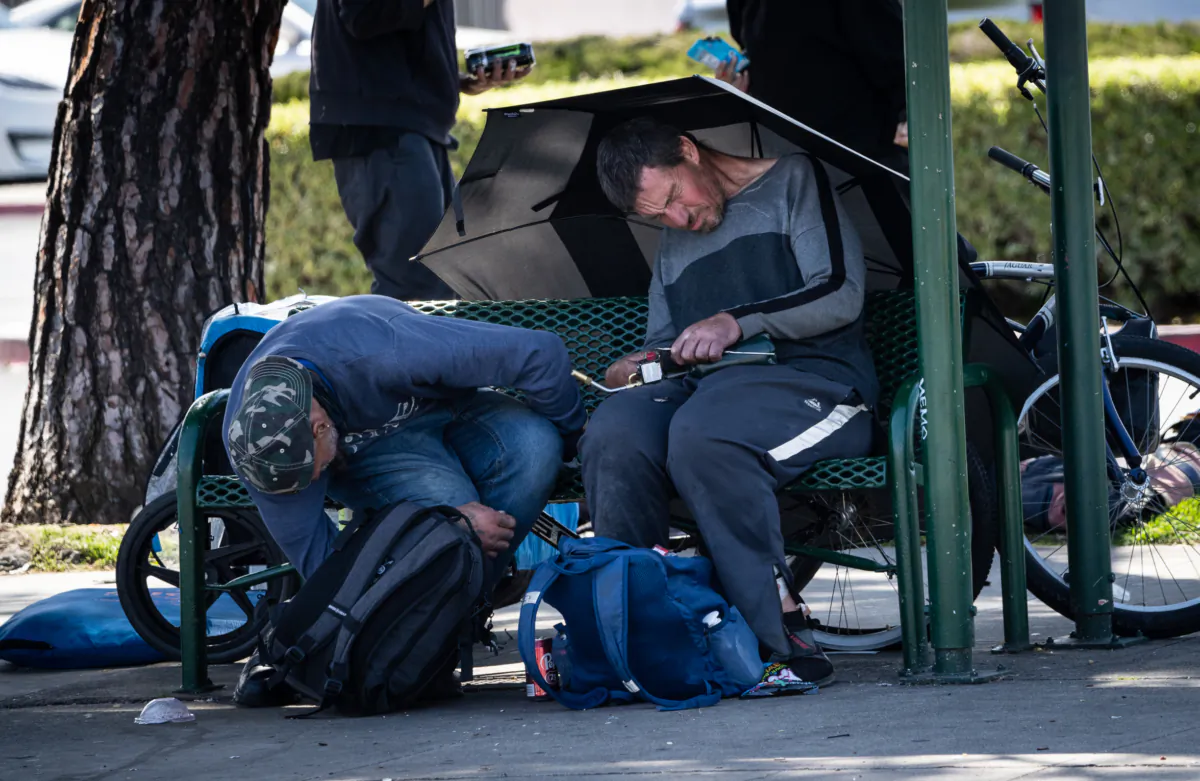 A homeless man holds a blowtorch he used to heat fentanyl in Garden Grove, Calif., on April 3, 2023. (John Fredricks/The Epoch Times)