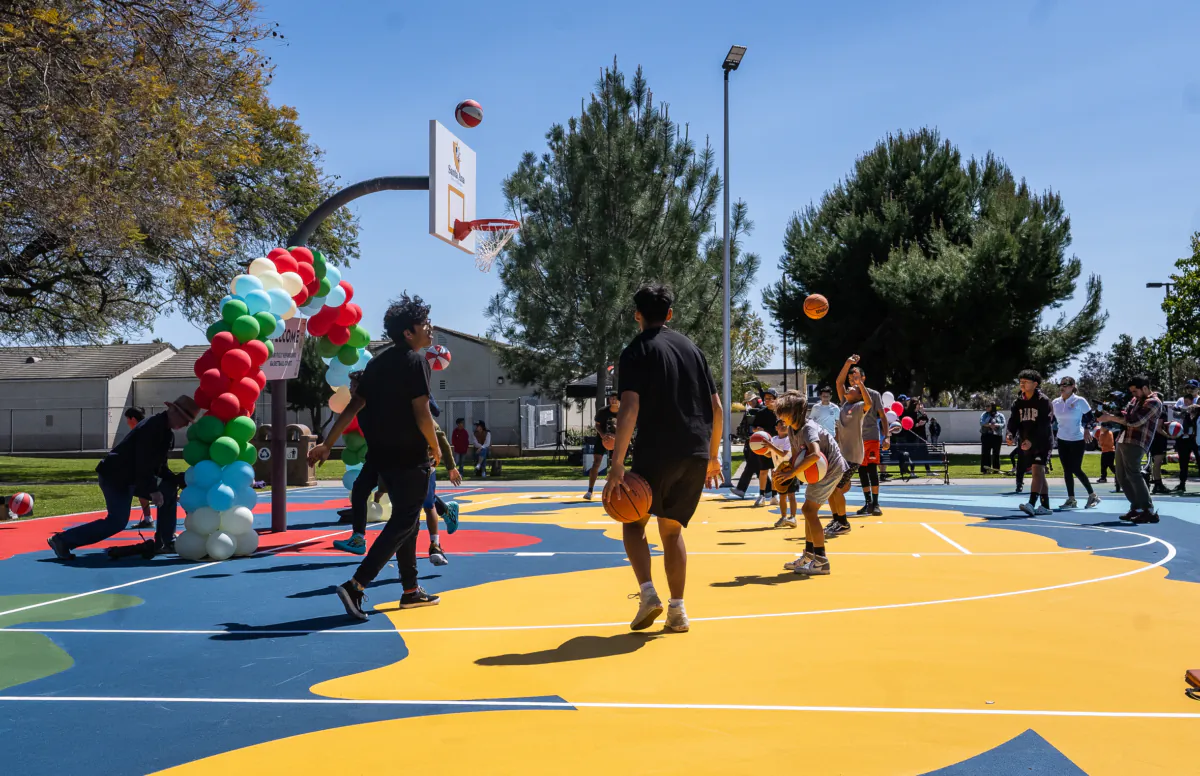 Kids enjoy the new Portola Park Basketball Court in Santa Ana, Calif., on April 4, 2023. (John Fredricks/The Epoch Times)