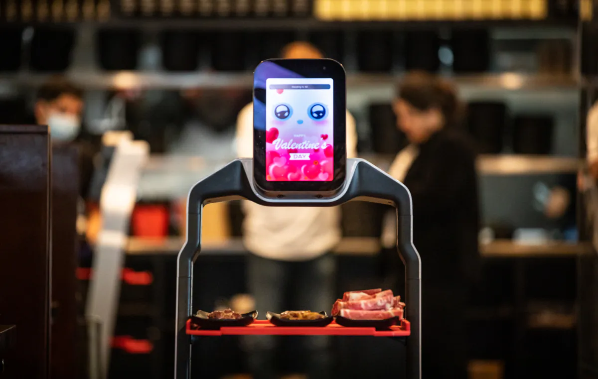A robot delivers food orders at I Can Korean Barbeque in Tustin, Calif., in Feb. 14, 2023. (John Fredricks/The Epoch Times)