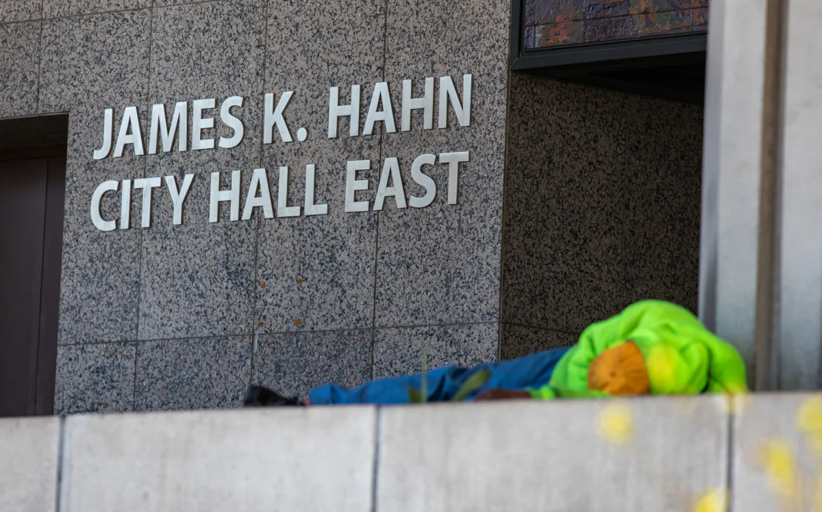 A homeless person sleeps at City Hall in Los Angeles on Jan 27, 2023. (John Fredricks/The Epoch Times)