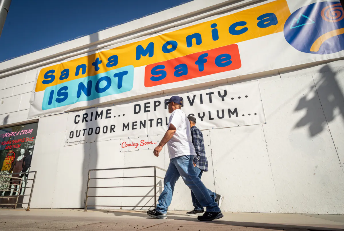 A sign hangs on display in front of a popular shopping area in Santa Monica, Calif., on Jan. 19, 2023. (John Fredricks/The Epoch Times)