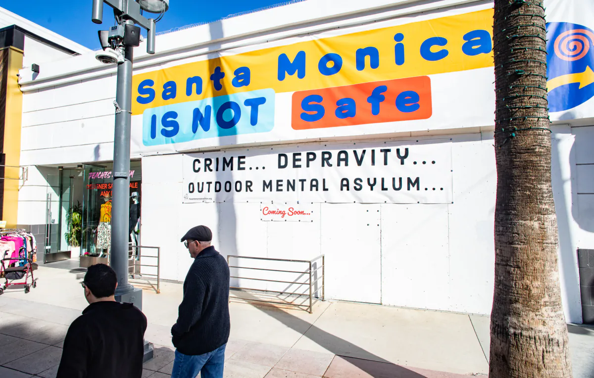 A sign sits on the display in front of a popular shopping area of Santa Monica, Calif., on Jan. 19, 2023. (John Fredricks/The Epoch Times)
