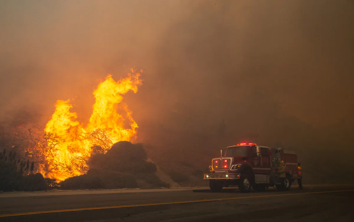 Firefighters work on extinguishing the Coastal Fire in Aliso Viejo, Calif., on May 11, 2022. (John Fredricks/The Epoch Times)