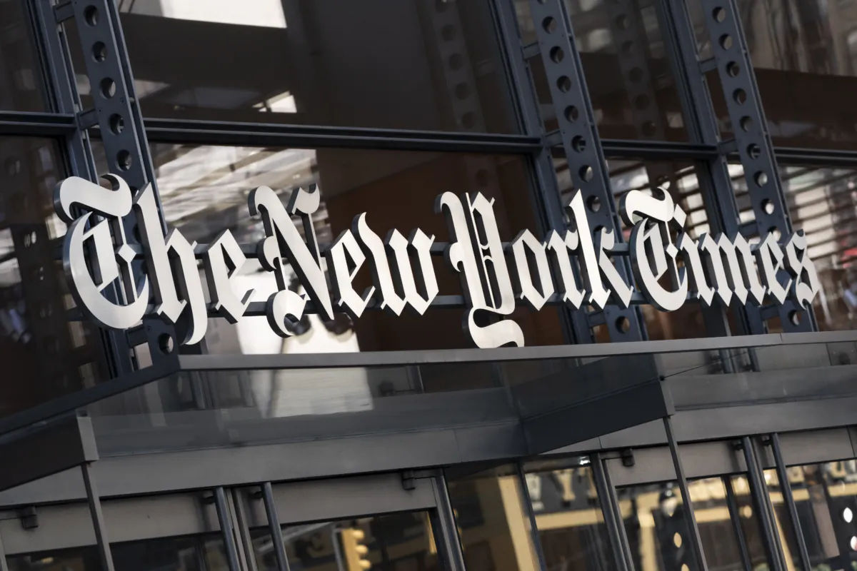 A sign for The New York Times hangs above the entrance to its building in New York on May 6, 2021. (Mark Lennihan/AP Photo)