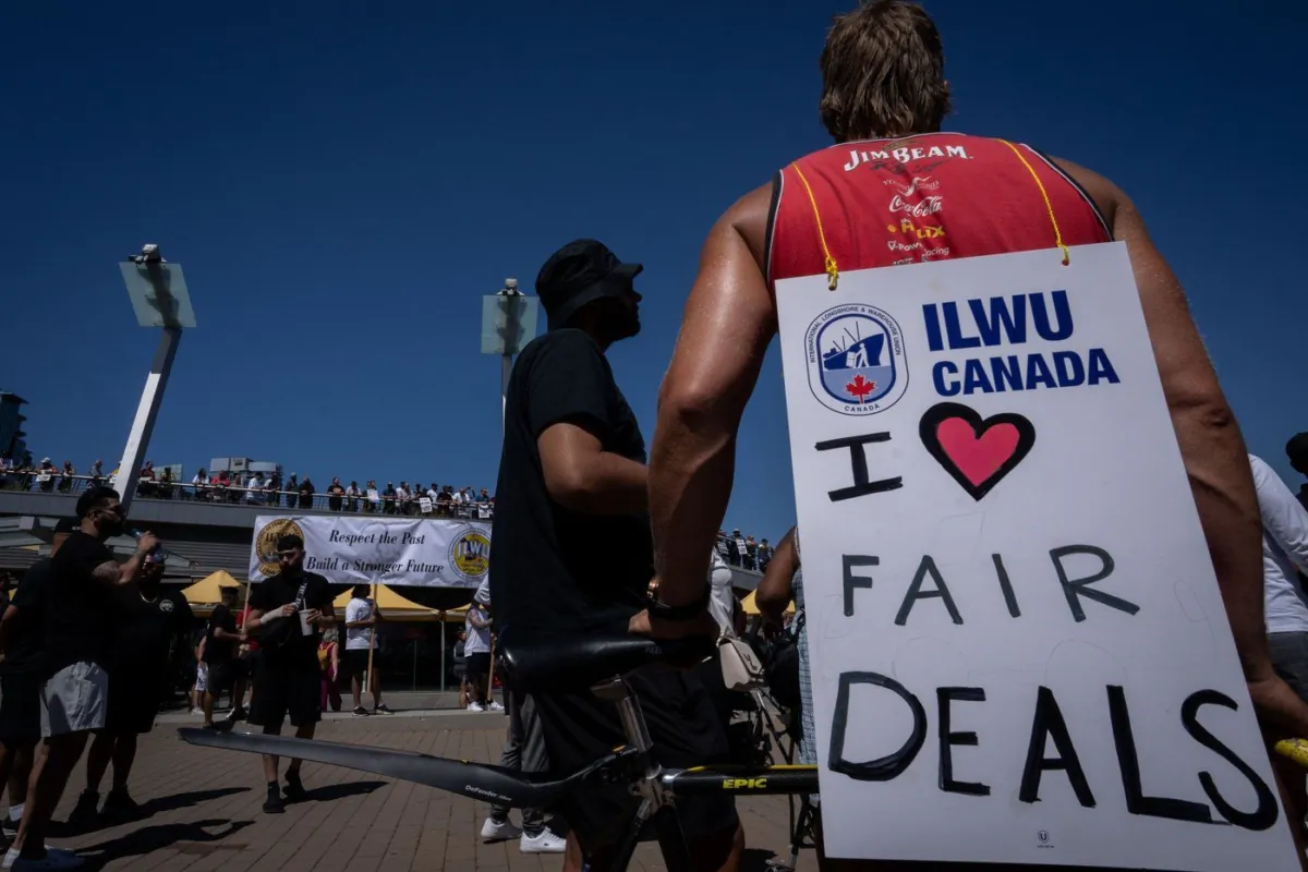 Striking port workers from the International Longshore and Warehouse Union Canada gather at Jack Poole Plaza while attending a rally in Vancouver, on July 9, 2023. (The Canadian Press/Ethan Cairns)
