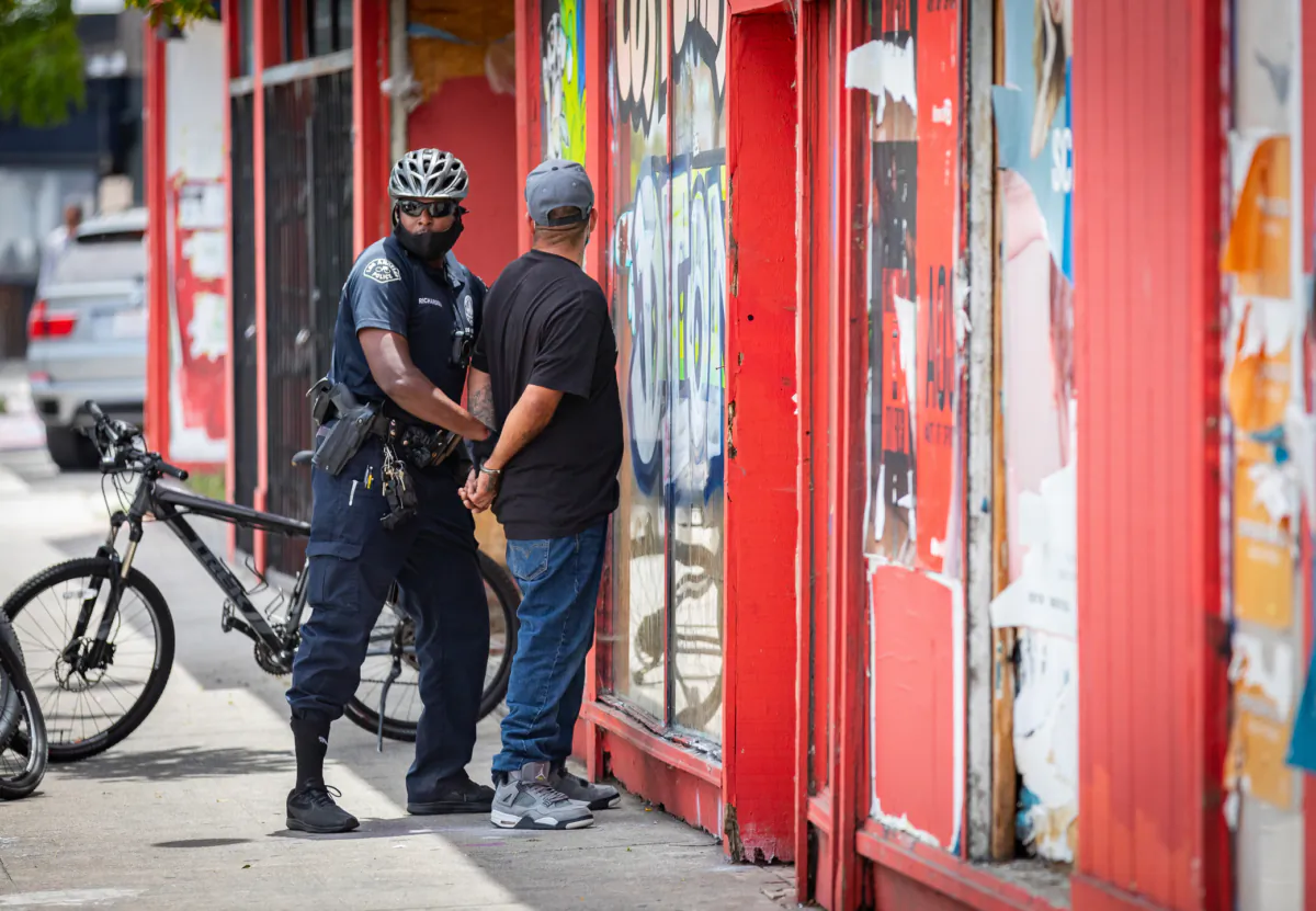 A man is arrested by an LAPD officer in Venice Beach, Calif.,on June 2, 2020. (John Fredricks/The Epoch Times)