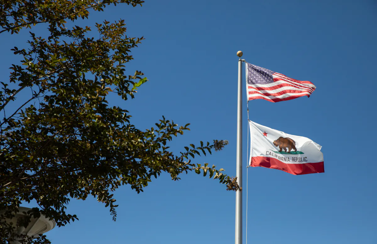 Flags fly at a school district in Costa Mesa, Calif., on Sept. 21, 2022. (John Fredricks/The Epoch Times)