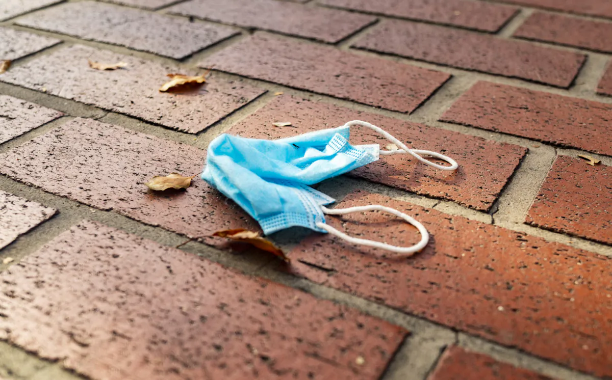 A mask lays disgared on a sidewalk in Orange, Calif., on June 19, 2020. (John Fredricks/The Epoch Times)