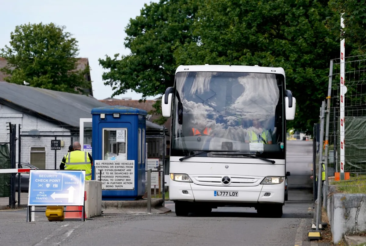 A coach with migrants onboard, leaves Manston immigration short-term holding facility in Manston, Kent, on July 10, 2023. (PA) 