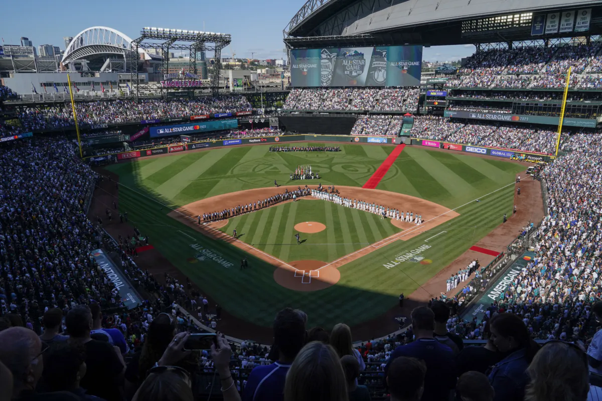 The All-Star Game logo is seen on the field at T-Mobile Park during the national anthem before the baseball game in Seattle, on July 11, 2023. (Ted S. Warren/AP Photo)