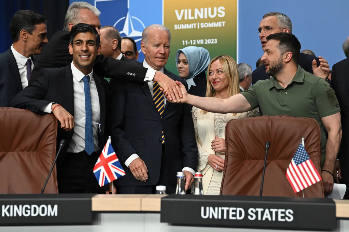Ukraine's President Volodymyr Zelensky (R) shakes hands with Lithuania's President Gitanas Nauseda (2nd L) next to (L-R) Spain's Prime Minister Pedro Sanchez, Turkey's President Recep Tayyip Erdogan, U.S. President Joe Biden, Italy's Prime Minister Giorgia Meloni, and NATO Secretary General Jens Stoltenberg at a meeting of the NATO-Ukraine Council during the NATO Summit in Vilnius, Lithuania, on July 12, 2023. (Paul Ellis/Pool/Getty Images)