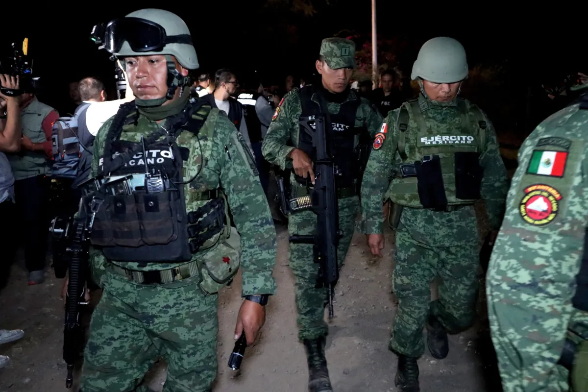 Army personnel, Jalisco prosecutors and forensic experts collect evidence after an explosives attack against police officers and staff from the state prosecutor's office in Tlajomulco de Zuniga, a suburb of the city of Guadalajara in Jalisco State, Mexico, on July 12, 2023. (Ulises Ruiz/AFP via Getty Images)
