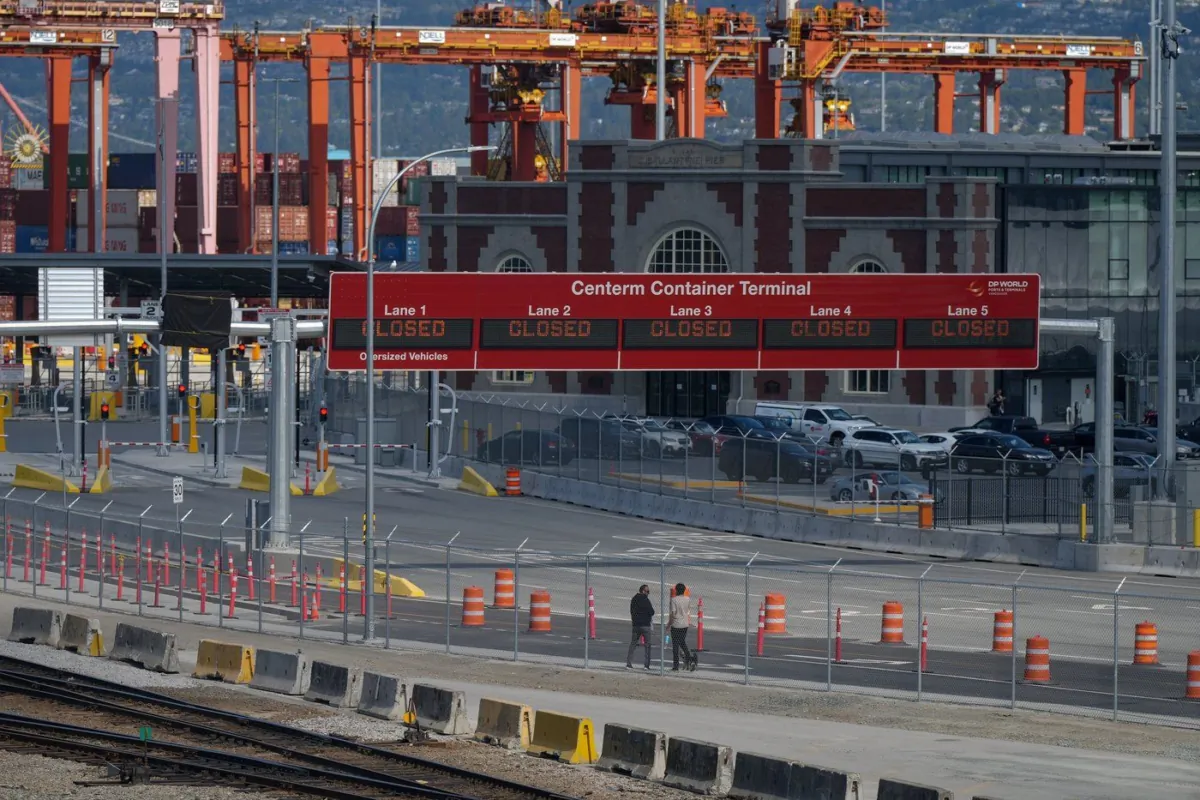 Signs displaying "closed" are seen at the Centerm Container Terminal as striking International Longshore and Warehouse Union Canada workers picket at the port, in Vancouver, B.C., July 11, 2023. (The Canadian Press/Darryl Dyck)