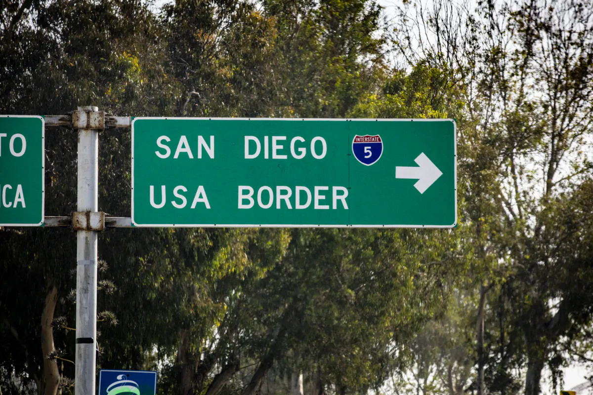 A road sign in Tijuana, Mexico points drivers to the U.S.-Mexico border city of San Diego on Nov. 6, 2021. (John Fredricks/The Epoch Times)