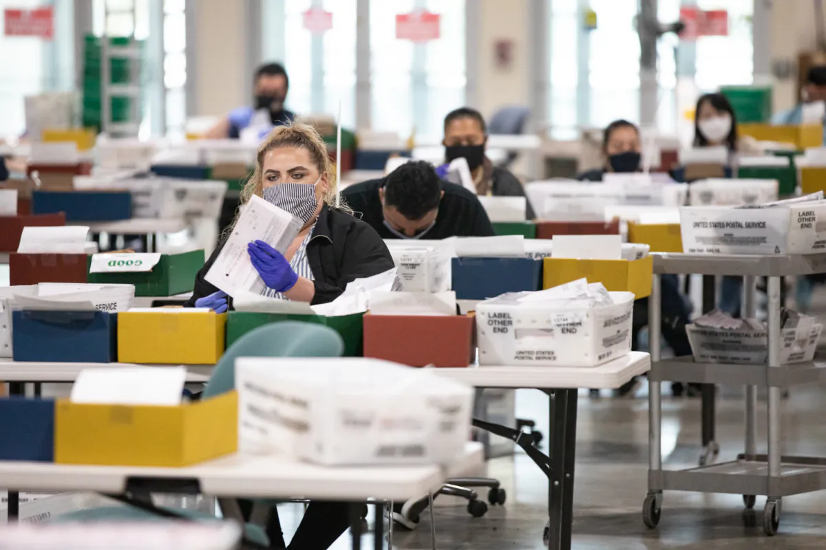 People count California recall ballot votes at a Los Angeles Registrar site at the Los Angeles Fair Grounds in Pomona, Calif., on Aug. 31, 2021. (John Fredricks/The Epoch Times)