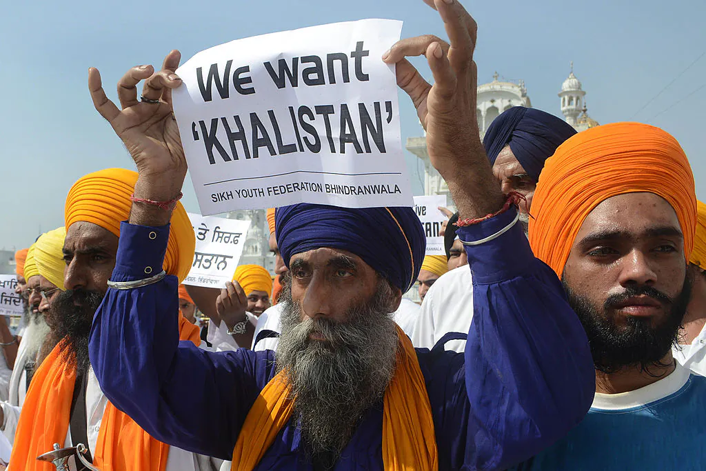 Activists from various radical Sikh organisations hold placards in support of Sikh leader Sant Jarnail Singh Bhindranwale and Khalistan, the name given for the envisioned independent Sikh state, after prayers at Sri Akal Takht at the Golden Temple in Amritsar, in Punjab, on June 6, 2013. (Narinder Nanu/AFP via Getty Images)