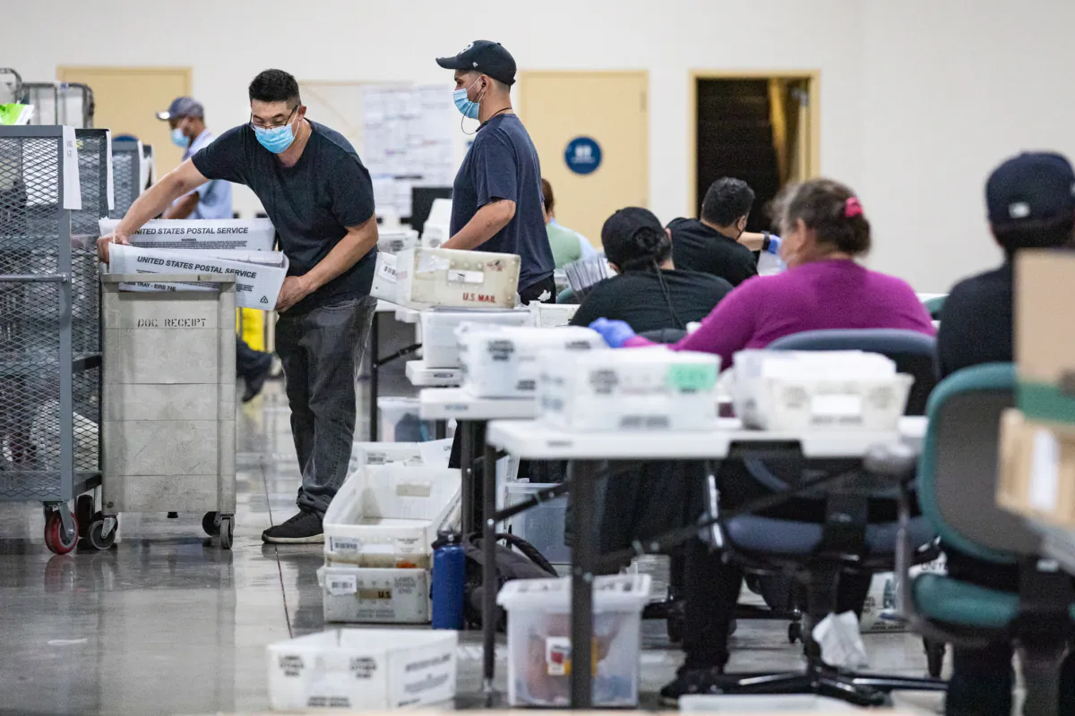 People count California recall ballot votes at a Los Angeles Registrar site at the Los Angeles Fair Grounds in Pomona, Calif., on Aug. 31, 2021. (John Fredricks/The Epoch Times)