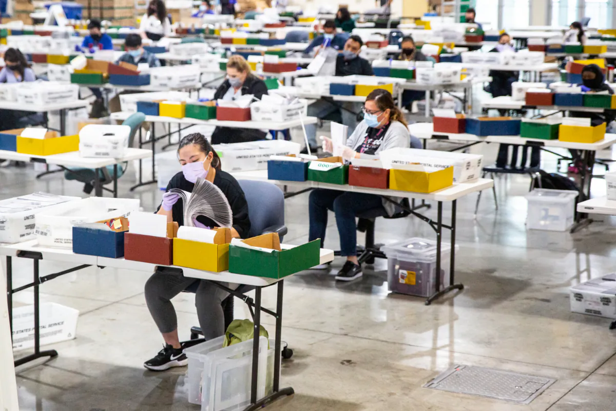 People process ballots at a Los Angeles Registrar site at the Los Angeles Fair Grounds in Pomona, Calif., on Aug. 31, 2021. (John Fredricks/The Epoch Times)