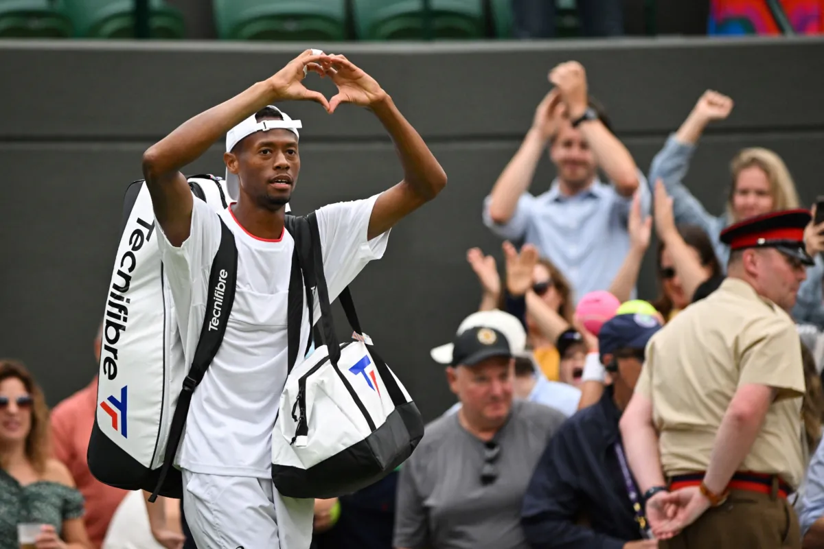US player Christopher Eubanks creates a heart with his hands as he acknowledges the audience while leaving the court following his defeat against Russia's Daniil Medvedev during their men's singles quarter-finals tennis match on the tenth day of the 2023 Wimbledon Championships at The All England Lawn Tennis Club in Wimbledon, southwest London, on July 12, 2023. (Glyn Kirk/AFP via Getty Images)
