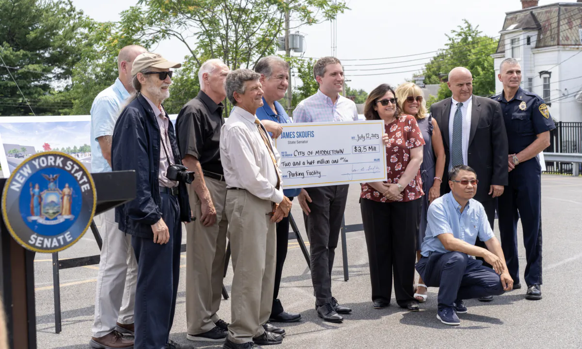New York state Sen. James Skoufis (center) announced a $2.5 million state funding for a future parking garage in downtown Middletown, N.Y., on July 12, 2023. (Cara Ding/The Epoch Times)