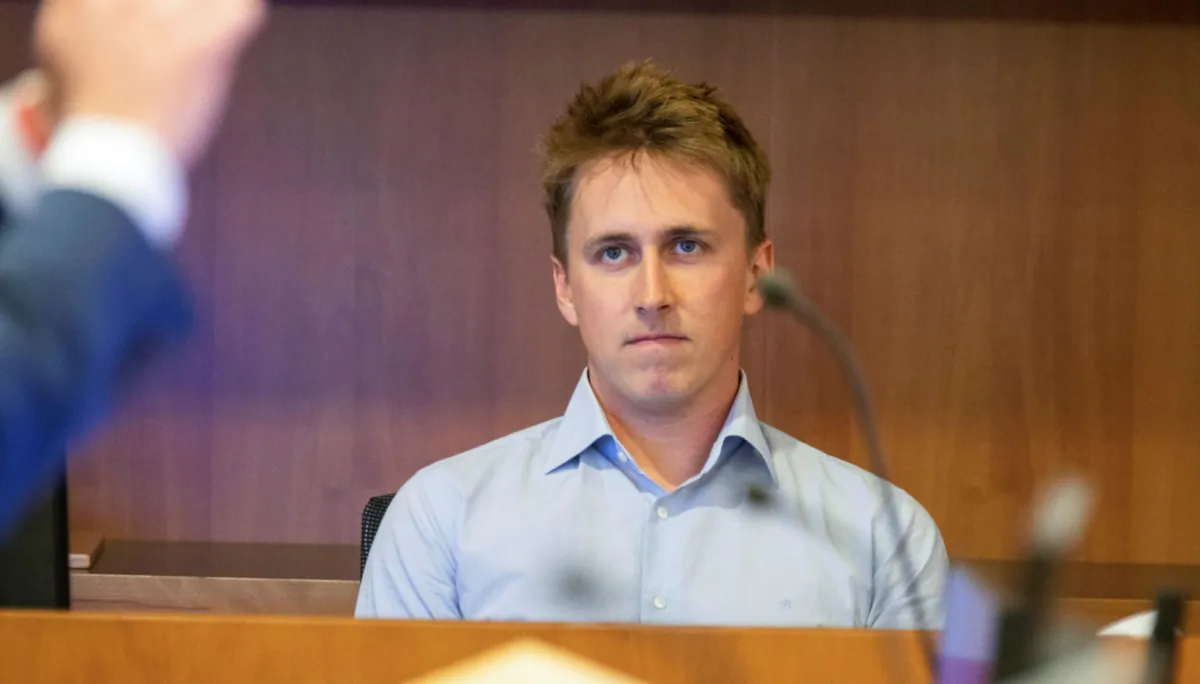 Pilot Brian Depauw reacts in the witness box at the Whakaari White Island eruption trial at the Auckland Environment Court, in Auckland, New Zealand, on July 13, 2023. (Nick Monro/Pool Photo via AP)