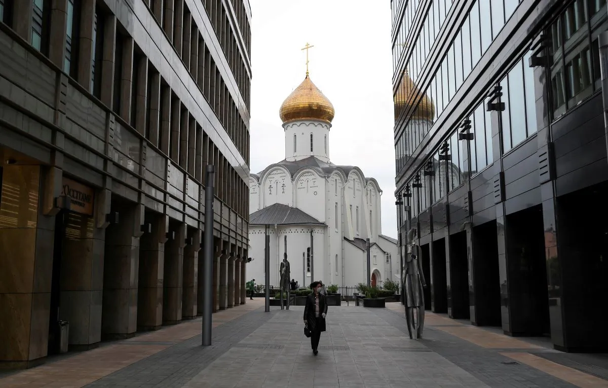 A woman wearing a protective face mask walks in a business district amid the outbreak of the coronavirus disease (COVID-19) in Moscow, Russia, on May 12, 2020. (Evgenia Novozhenina/Reuters)
