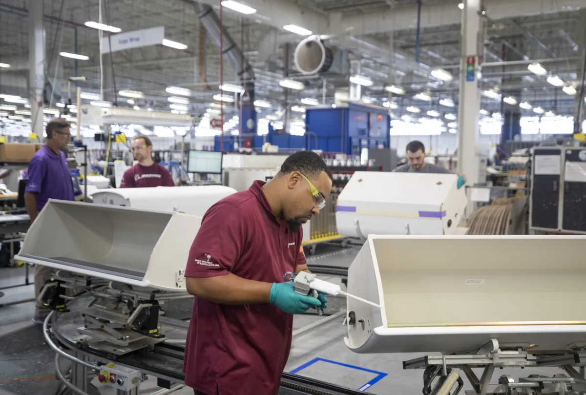 Employees work on the construction line for overhead bins at the Boeing Interiors Responsibility Center in North Charleston, S.C., on May 31, 2023. (Gavin McIntyre/Pool/The Post And Courier via AP)