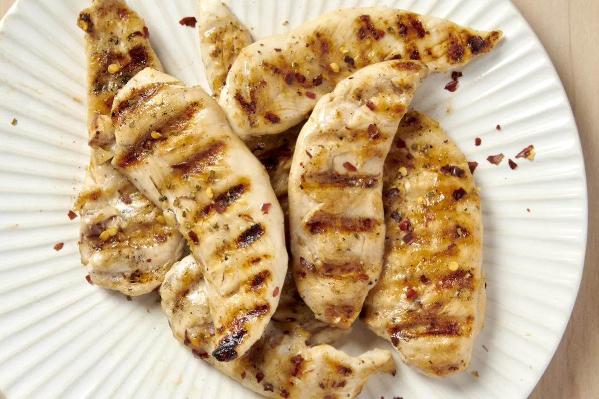Juicy unbreaded chicken tenders come together with an easy marinade and a few minutes on the grill. (Alex Lepe;/TNS)