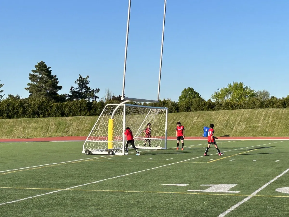 Youth soccer players move a net into position at Centennial Park in Toronto on May 25, 2023. (The Canadian Press/Liam Casey)

