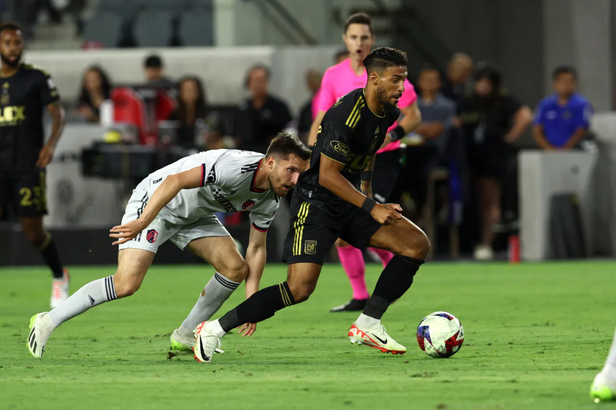 LAFC forward Denis Bouanga (99) dribbles past St. Louis City SC defender at BMO Stadium in Los Angeles on July 12, 2023. (Courtesy of LAFC via The Epoch Times)
