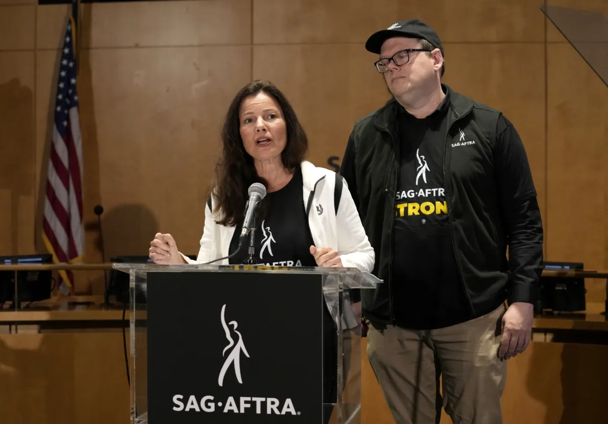 SAG-AFTRA president Fran Drescher (L) and SAG-AFTRA National Executive Director and Chief Negotiator Duncan Crabtree-Ireland speak during a press conference announcing a strike by The Screen Actors Guild-American Federation of Television and Radio Artists in Los Angeles on July, 13, 2023. (Chris Pizzello/AP Photo)