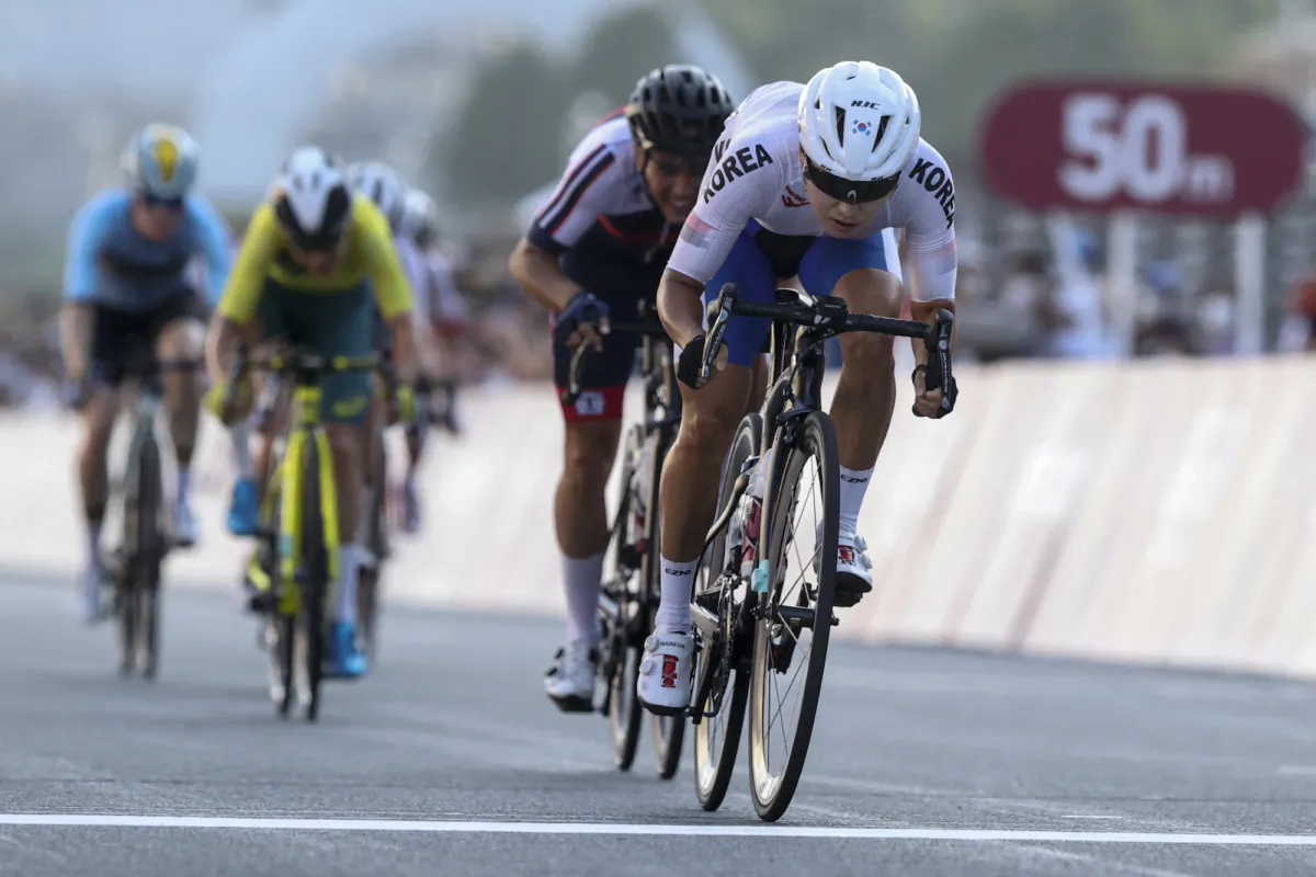 South Korea's Na Ahreum sprints to cross the finish line in 38th position during the women's cycling road race of the Tokyo 2020 Olympic Games at the Fuji International Speedway in Oyama, Japan, on July 25, 2021. (Michael Steele/AFP via Getty Images)
