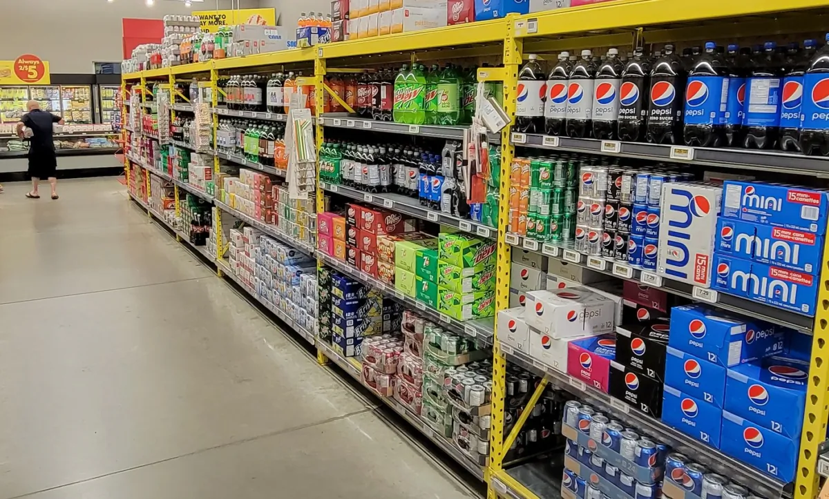 A customer walks down a grocery store's drinks aisle in Newcastle, Ont., on July 13, 2023. (The Canadian Press/Doug Ives)