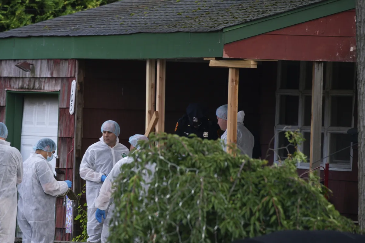 Crime laboratory officers arrive to the house where a suspect has been taken into custody on New York's Long Island in connection with a long-unsolved string of killings, known as the Gilgo Beach murders, in Massapequa Park, N.Y., on July 14, 2023. (Eduardo Munoz Alvarez/AP Photo)