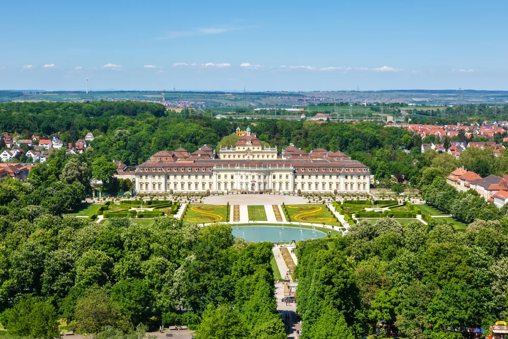 The Ludwigsburg Palace, designed by Italian architect Donato Giuseppe Frisoni, resides at the center of the German city of Ludwigsburg. The Baroque complex expanded to four wings around the palace courtyard. The central building is enclosed by the hunting and gaming pavilions and hosts state apartments. The large garden is in the formal French and naturalistic English styles, with lush trees, symmetric lawns, flower borders, and water features. (Markus Mainka/Shutterstock)