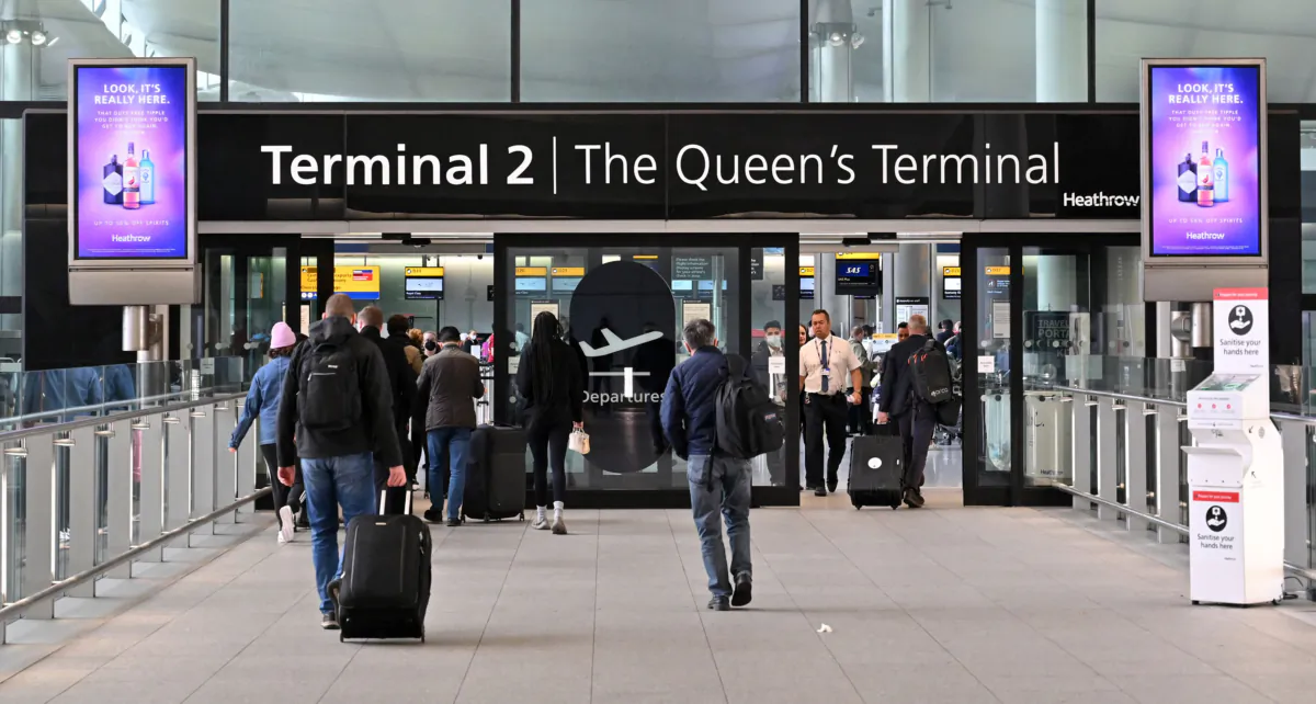 Travelers arrive at Terminal 2 of London Heathrow Airport in west London, on April 6, 2022. (Justin Tallis/AFP/Getty Images/TNS)