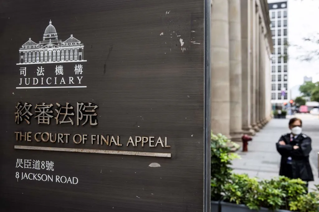 A security guard stands outside the Court of Final Appeal in Hong Kong on March 31, 2022. Australian and Canadian judges confirmed on March 31, 2022 that they will stay on Hong Kong's top court after two senior British judges resigned to avoid endorsing China's crackdown on political freedoms in the financial hub. (Isaac Lawrence/AFP via Getty Images)