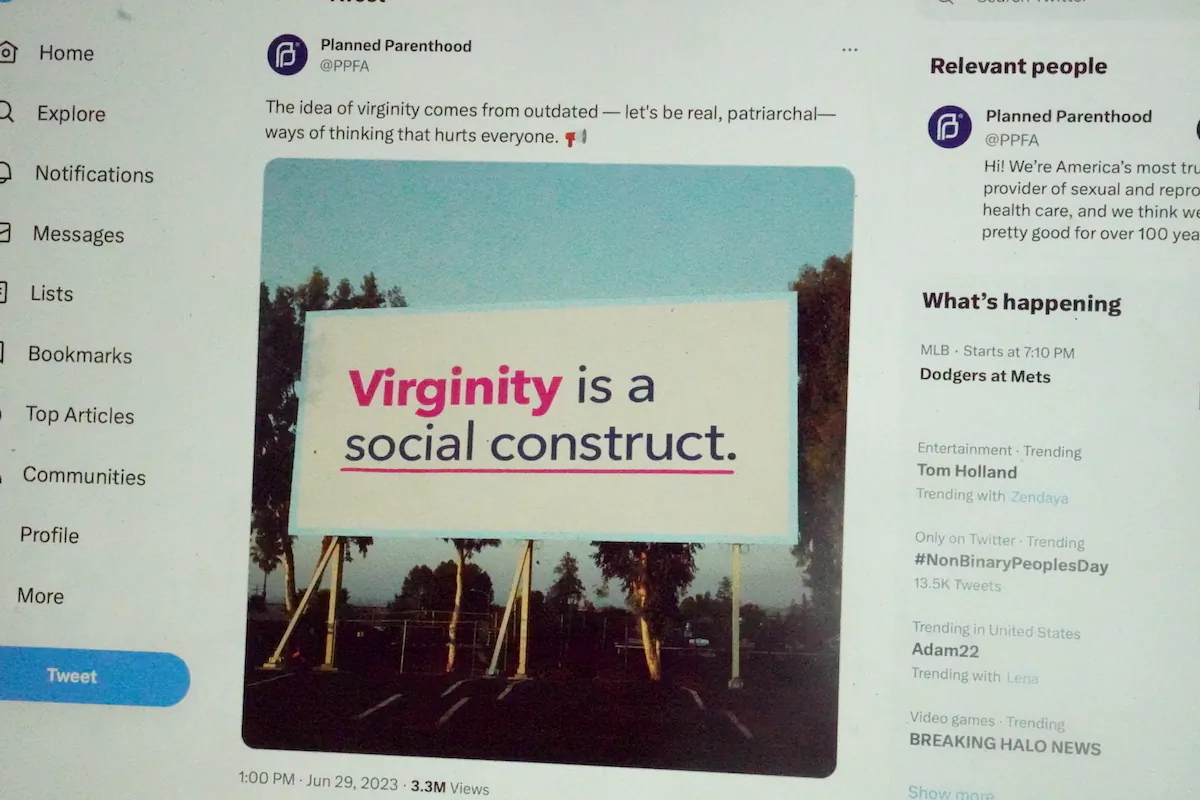 A computer screen shows a Twitter post by Planned Parenthood that includes a billboard with the words "Virginity is a social construct" on July 14, 2023. (Jackson Elliott/The Epoch Times) 