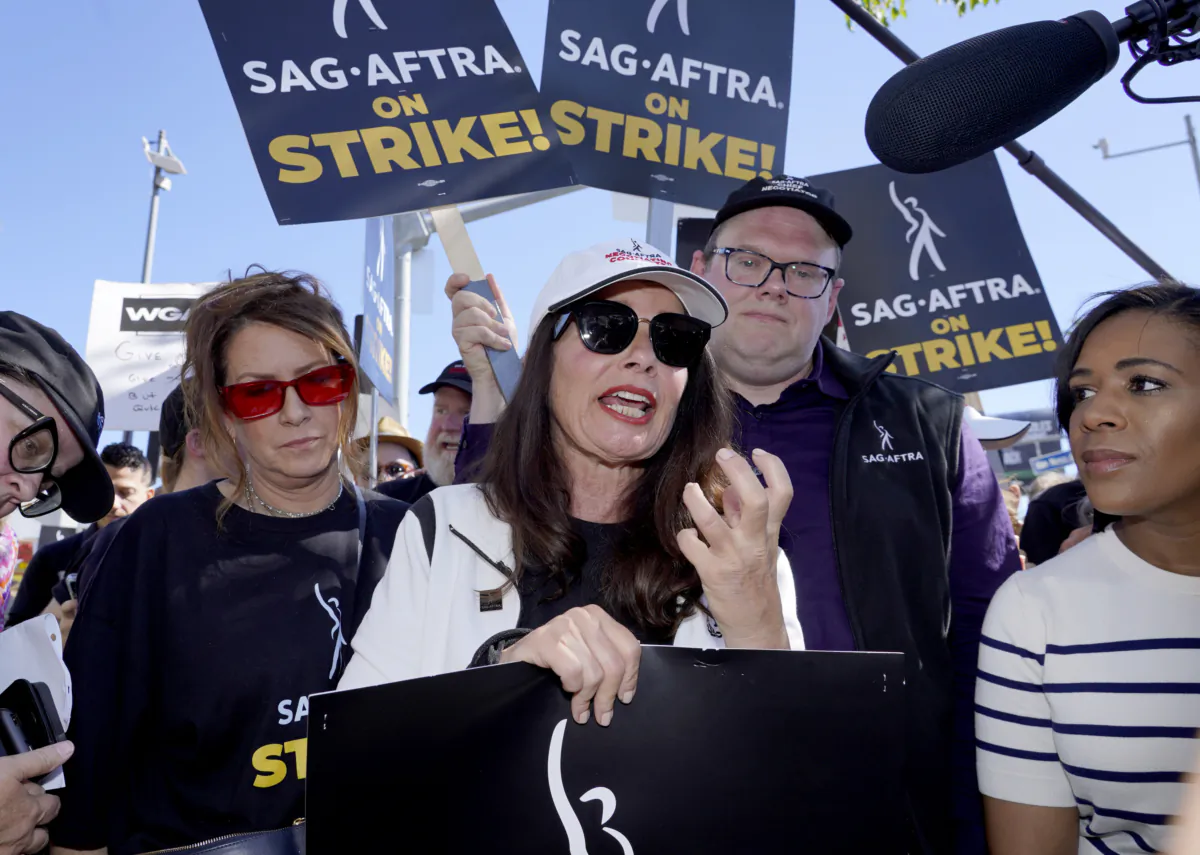 (Left-right) Actress Joely Fisher, SAG-AFTRA president Fran Drescher, and SAG-AFTRA national executive director and chief negotiator Duncan Crabtree-Ireland take part in a rally by striking writers and actors outside Netflix studio in Los Angeles on July 14, 2023. (Chris Pizzello/AP Photo)