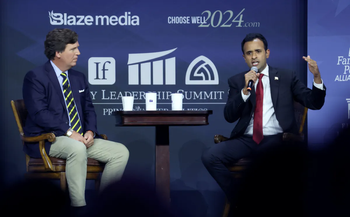 Republican presidential candidate Vivek Ramaswamy fields questions from former Fox News Television host Tucker Carlson at the Family Leadership Summit in Des Moines, Iowa, on July 14, 2023. (Scott Olson/Getty Images)